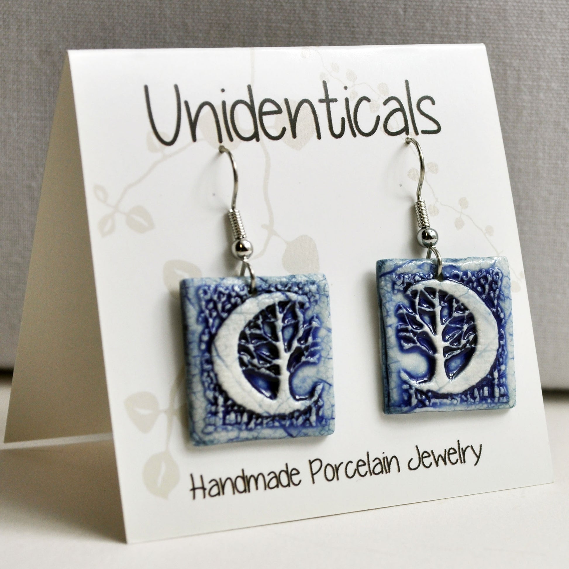 EMS727 Crescent Moon Tree Blue Square Earrings on tent card.jpg